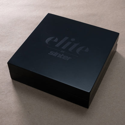 Sinter Elite presentation box closed, matte-black wooden case with embossed elite by sinter logo on the lid